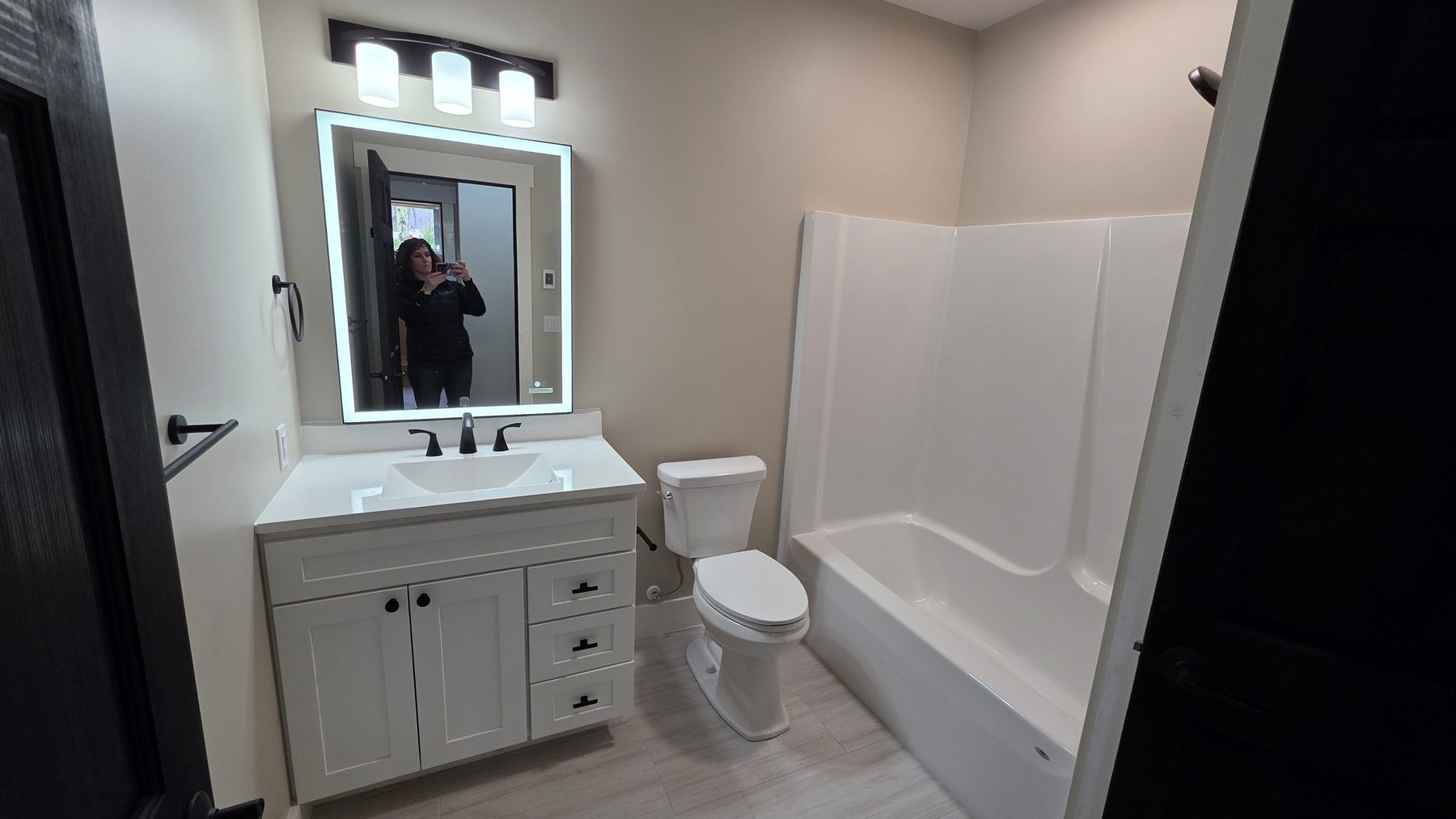 Bright bathroom with tub-shower combo and modern vanity