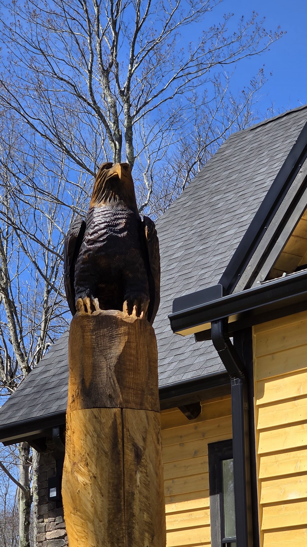 Carved eagle sculpture on a wooden post near the property