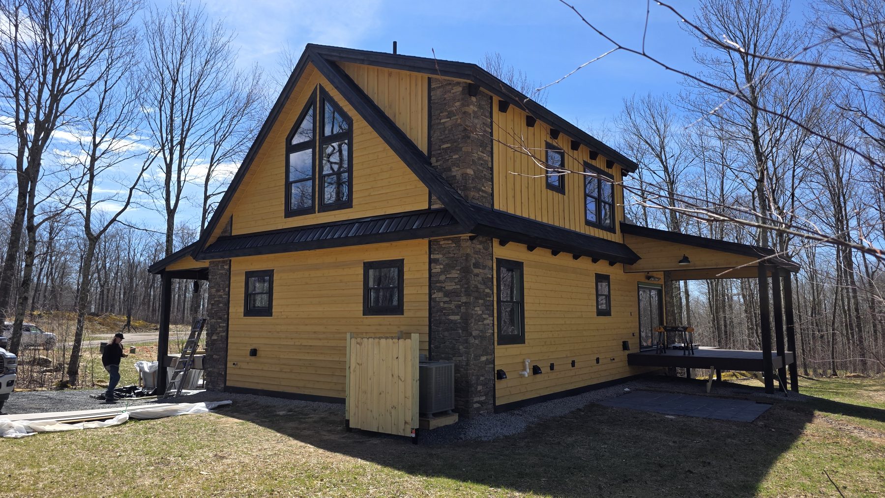 Side exterior view of the yellow mountain home with covered porch