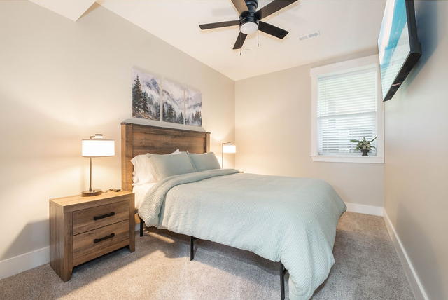 A lower-level queen tucked off the game room — dark and quiet, good for an after
