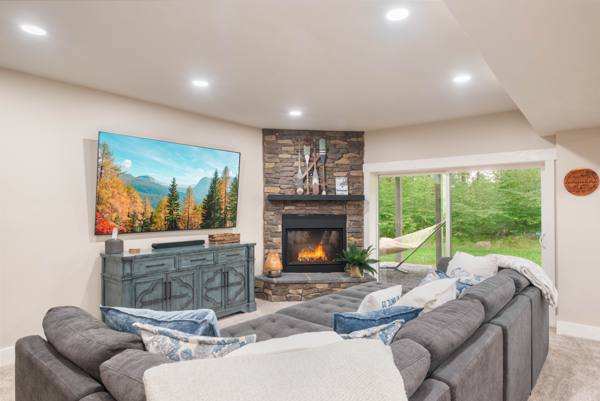 The lower level: a pit-style sectional facing an 85-inch screen and the second s