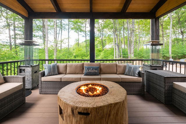 The gas fire table on the covered deck. Turn the knob and settle in — the 